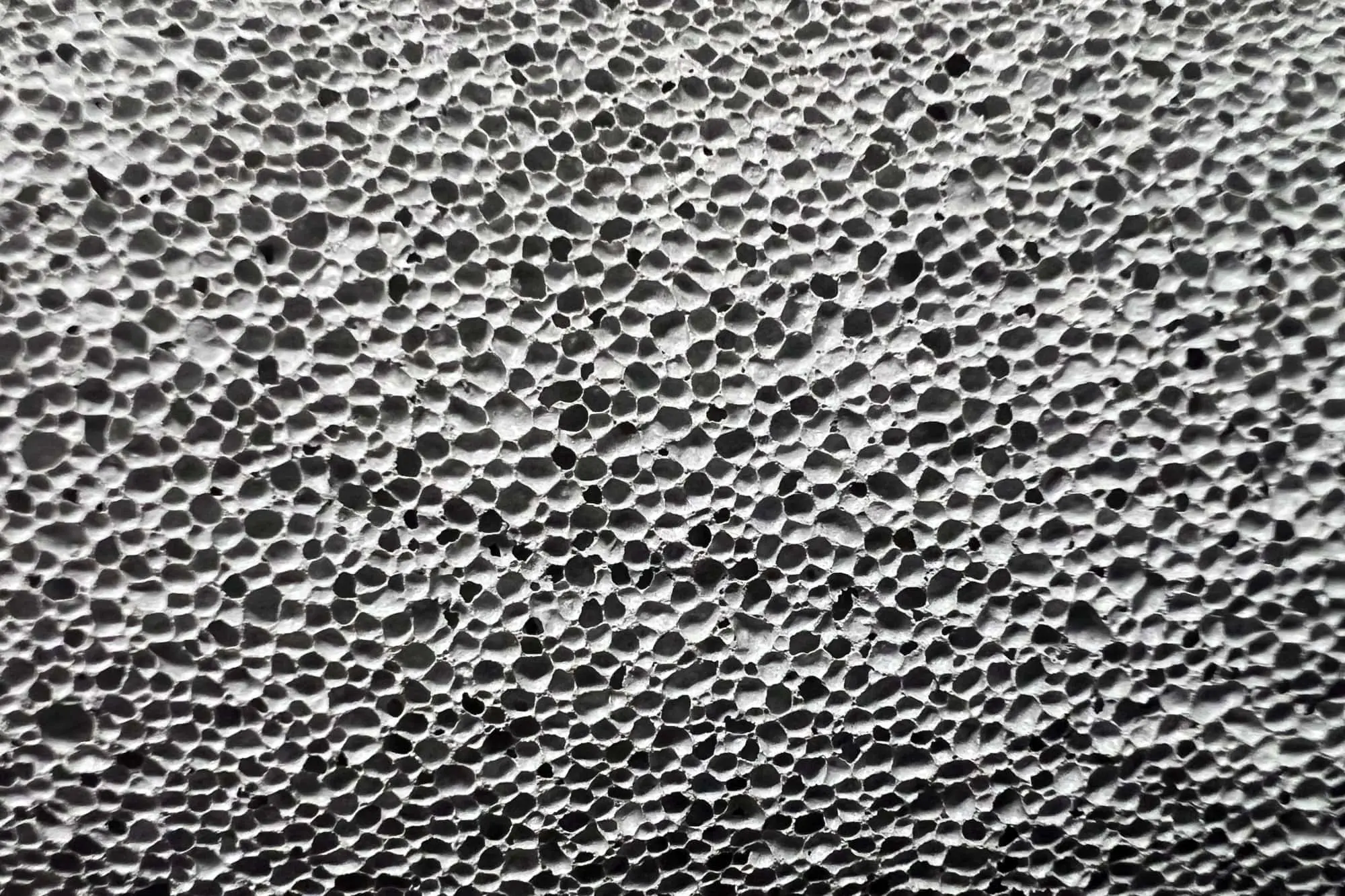 Close-up view of lightweight cellular concrete highlighting the air voids that reduce weight while maintaining strength